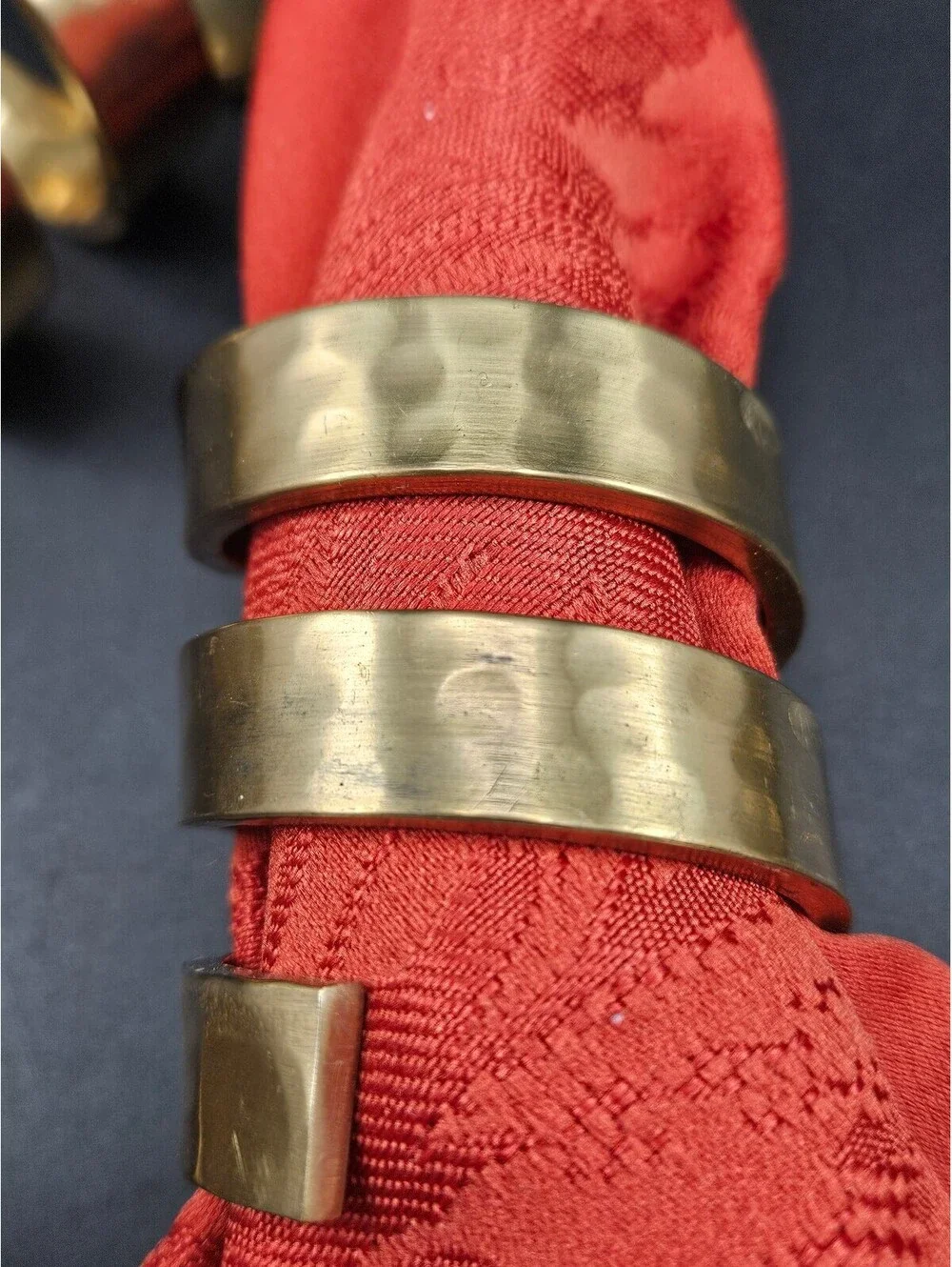 Set of 4 Spiral Hammered Brass Napkin Rings and 4 Red Napkins